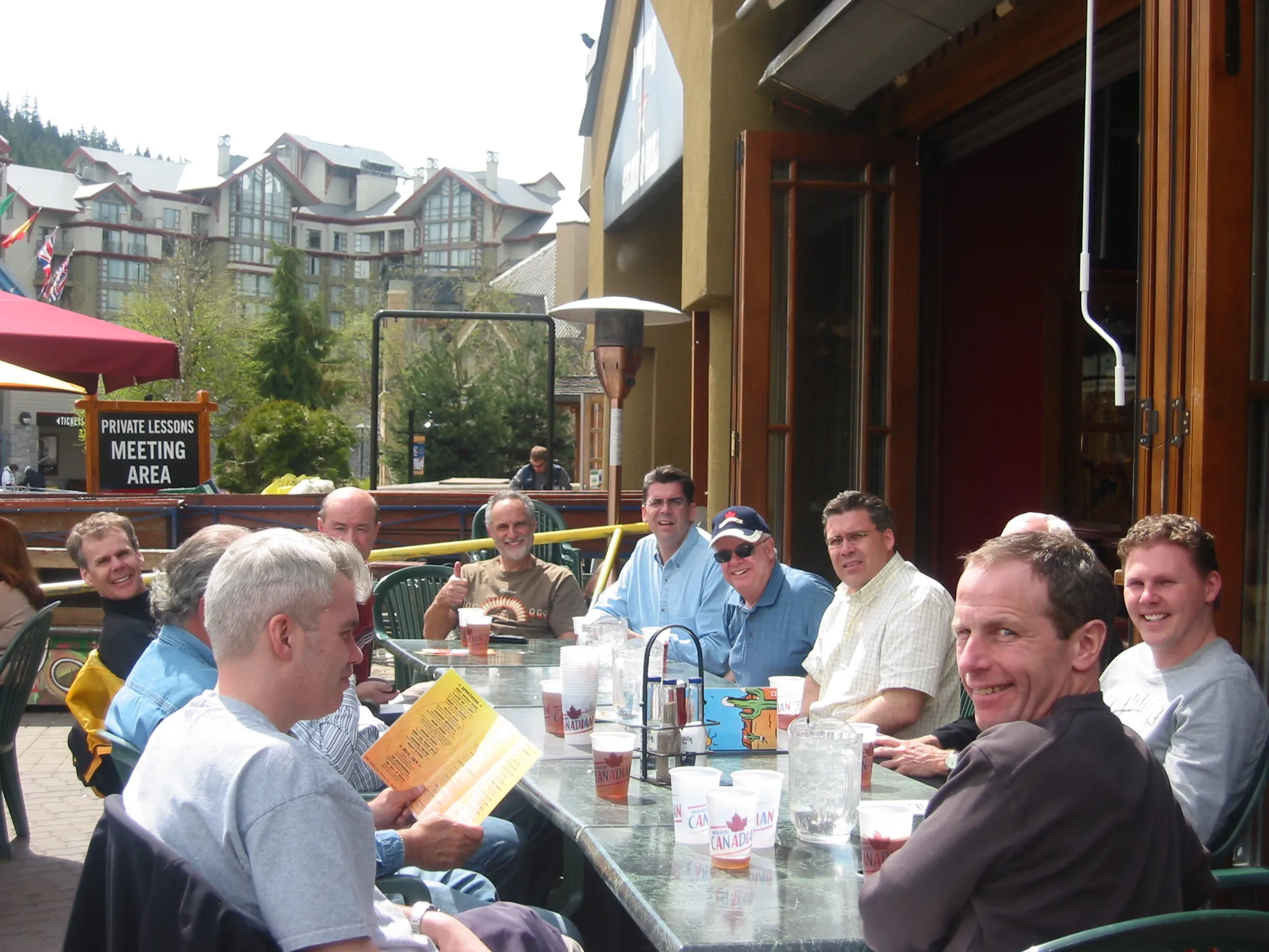 The executive team and board around a patio table in Whistler after the project presentation.