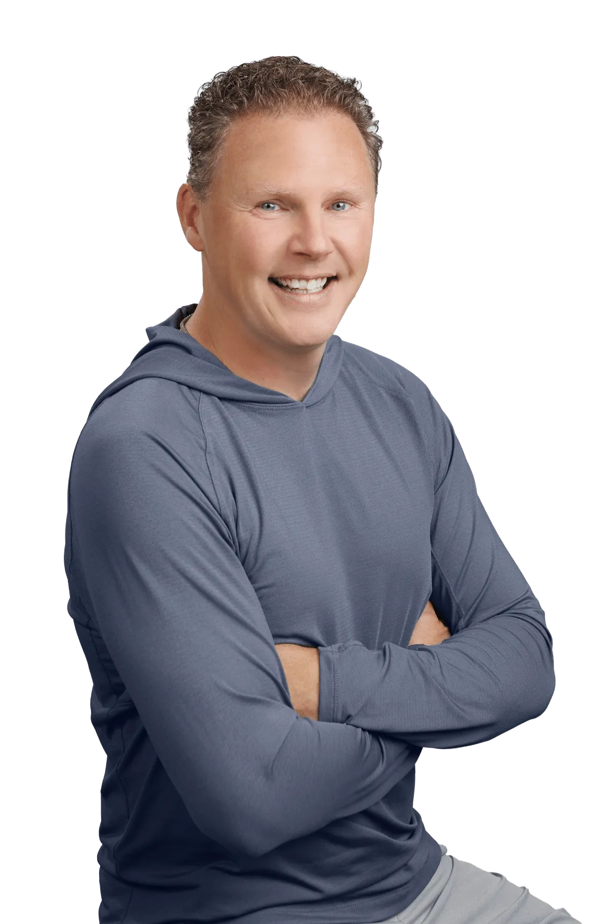 Chad Richardson standing with his arms crossed, smiling at the camera.